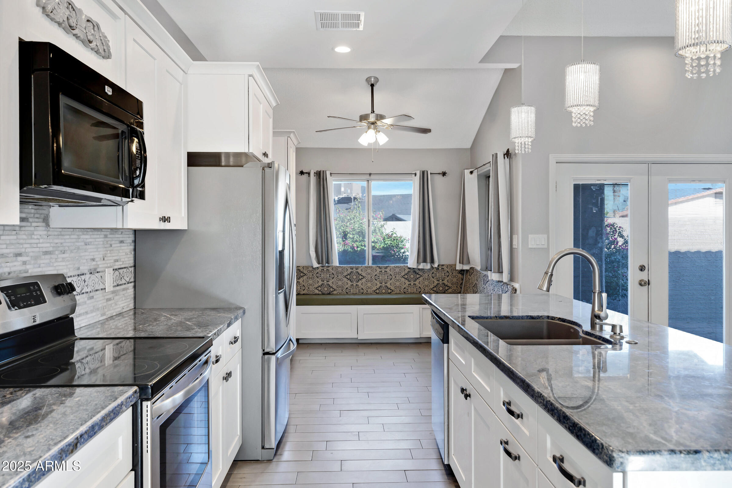 792 West El Monte Place, Unit 8 Chandler, AZ 85225 - Photo 16 of 33 a kitchen with granite countertop a sink a counter top space appliances and cabinets
