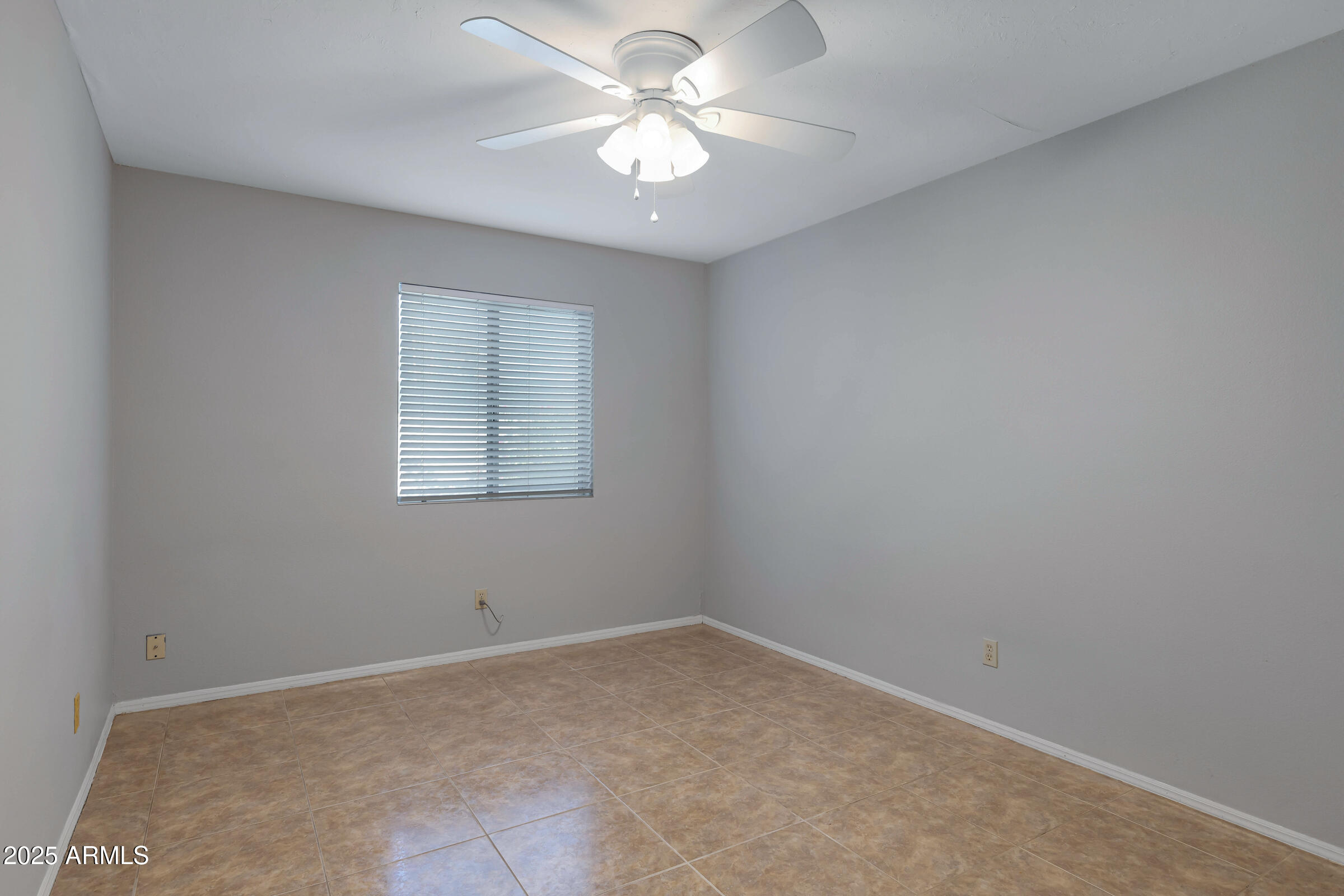 792 West El Monte Place, Unit 8 Chandler, AZ 85225 - Photo 20 of 33 an empty room with windows and ceiling fan