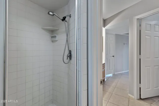 a bathroom with a glass shower door