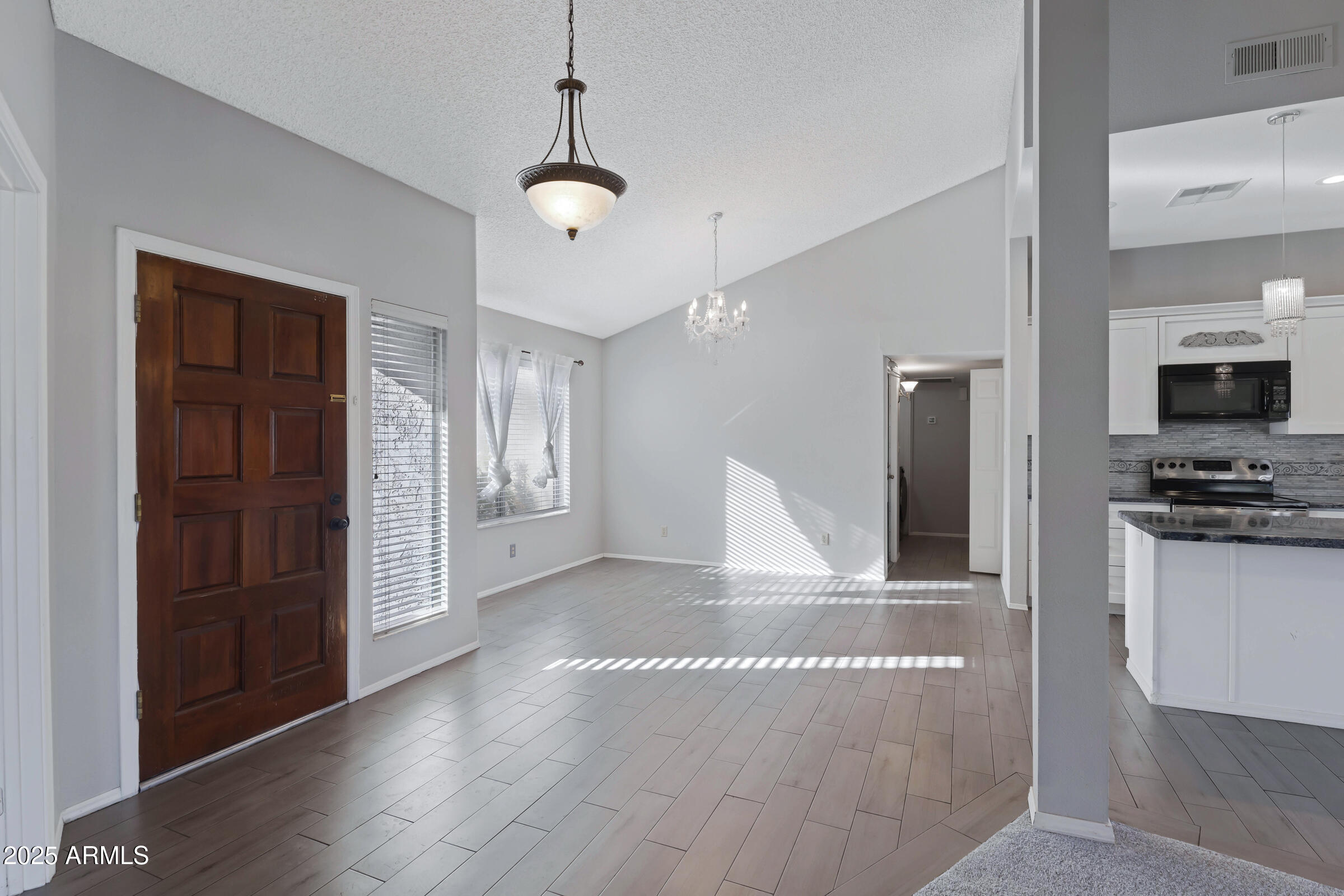 792 West El Monte Place, Unit 8 Chandler, AZ 85225 - Photo 5 of 33 a view of a kitchen with refrigerator and wooden floor