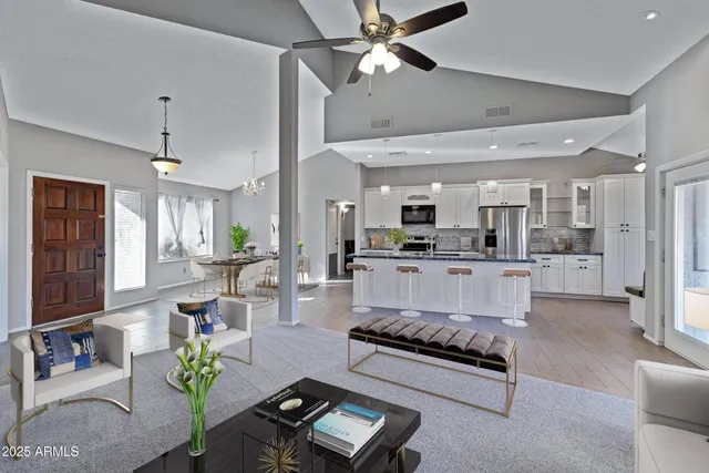 a living room with furniture and kitchen view