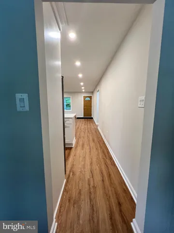 a kitchen with stainless steel appliances kitchen island granite countertop a stove a sink and a refrigerator