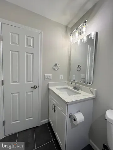 a bathroom with a sink toilet and mirror