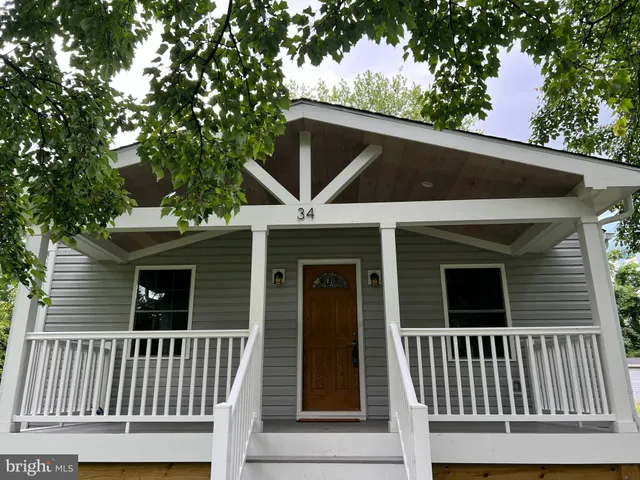 a view of a house with a small deck