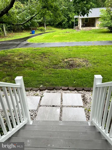 a view of a deck with wooden floor and a yard