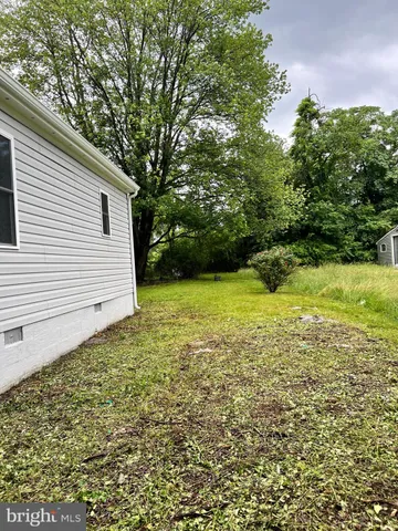 a view of backyard with a deck