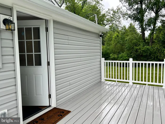 a view of a porch with wooden floor