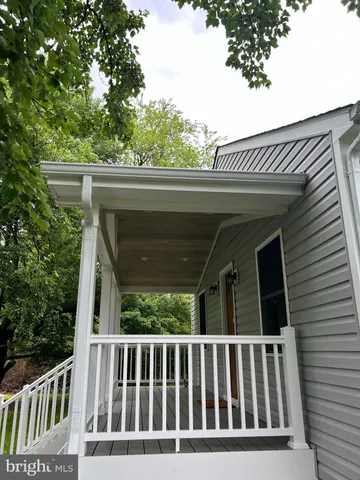 a view of backyard with a balcony