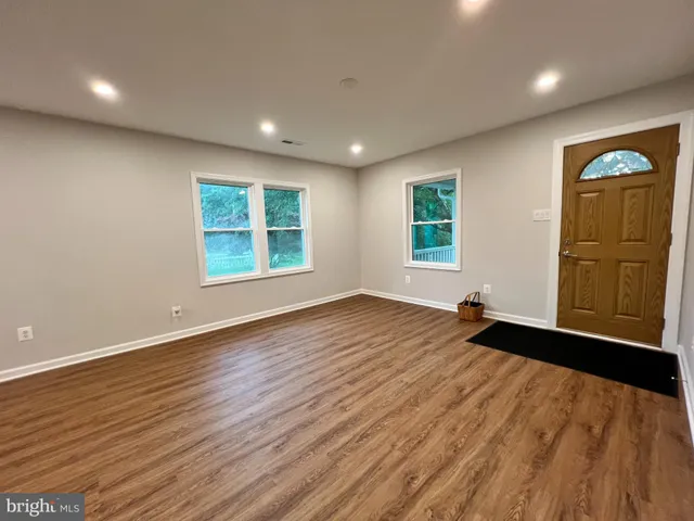a kitchen with kitchen island wooden cabinets and white appliances