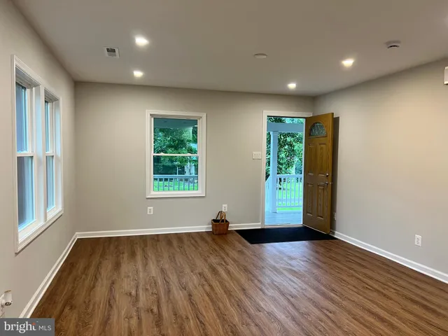 a kitchen with a sink a microwave a refrigerator and cabinets