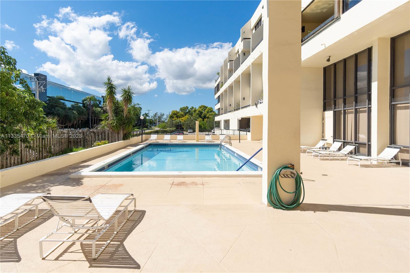 1401 South Federal Highway, Unit 204 Boca Raton, FL 33432 - Photo 18 of 22 a view of a swimming pool with a lounge chair