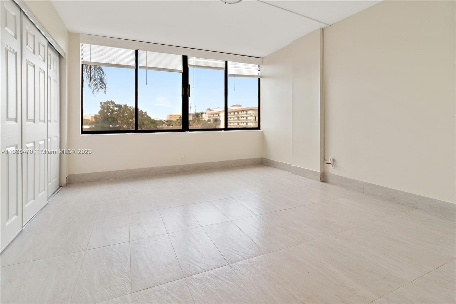 1401 South Federal Highway, Unit 204 Boca Raton, FL 33432 - Photo 8 of 22 an empty room with wooden floor and windows