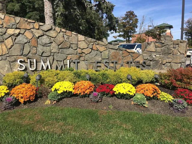 a view of a lake with a table and chairs