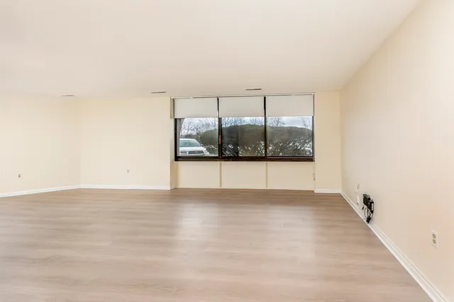 a view of an empty room and wooden floor