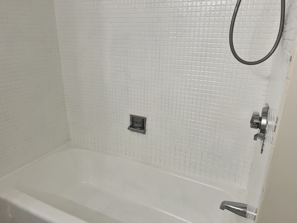 1002 Paradise Road, Unit 1M Swampscott, MA 01907 - Photo 18 of 25 a bathroom with a bath tub and a shower