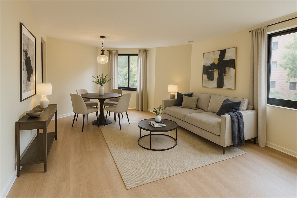 1002 Paradise Road, Unit 1M Swampscott, MA 01907 - Photo 5 of 25 a living room with furniture a large window and glass table