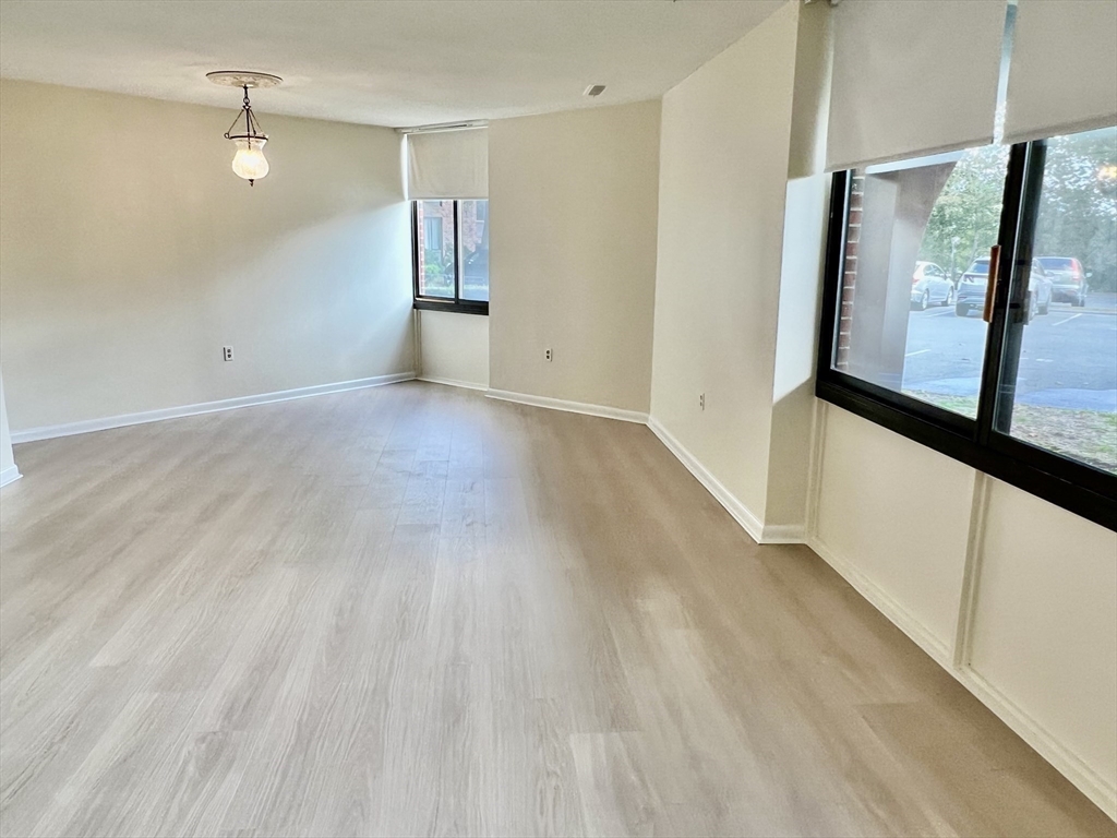1002 Paradise Road, Unit 1M Swampscott, MA 01907 - Photo 6 of 25 a view of empty room with wooden floor