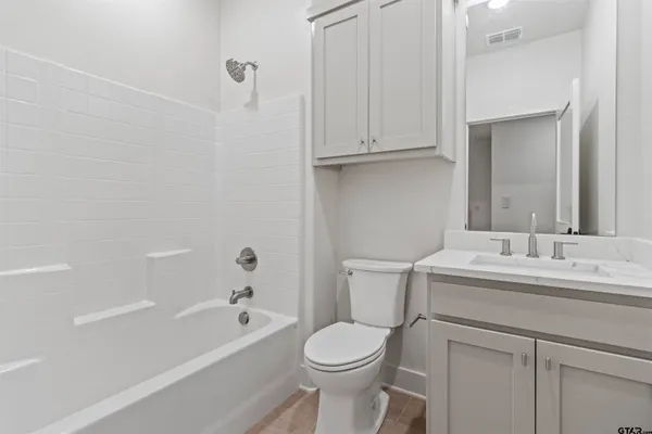 a bathroom with a toilet sink and bathtub