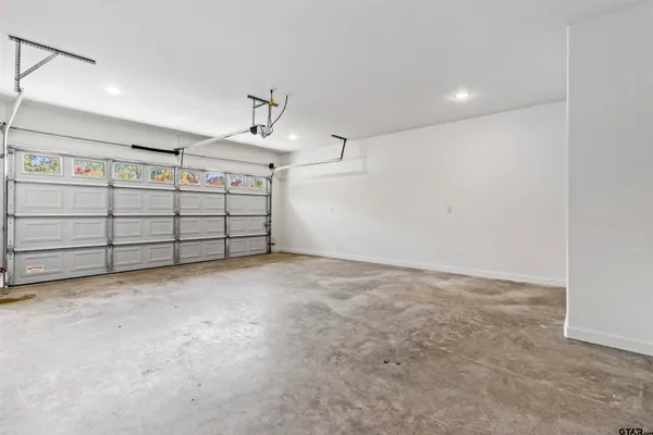 a view of a house with a yard and potted plants