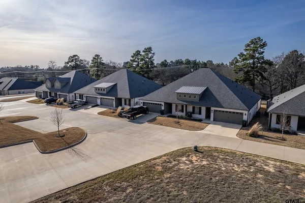 an aerial view of a house with swimming pool and mountains