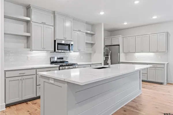 a kitchen with a sink stove and refrigerator