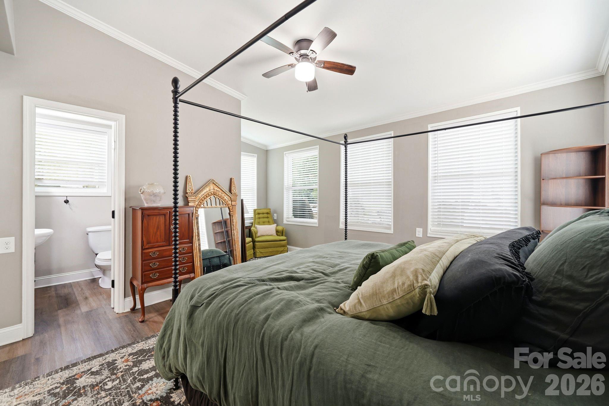 7552 Idlewild Road Charlotte, NC 28212 - Photo 19 of 40 a bed sitting in a bedroom next to a window