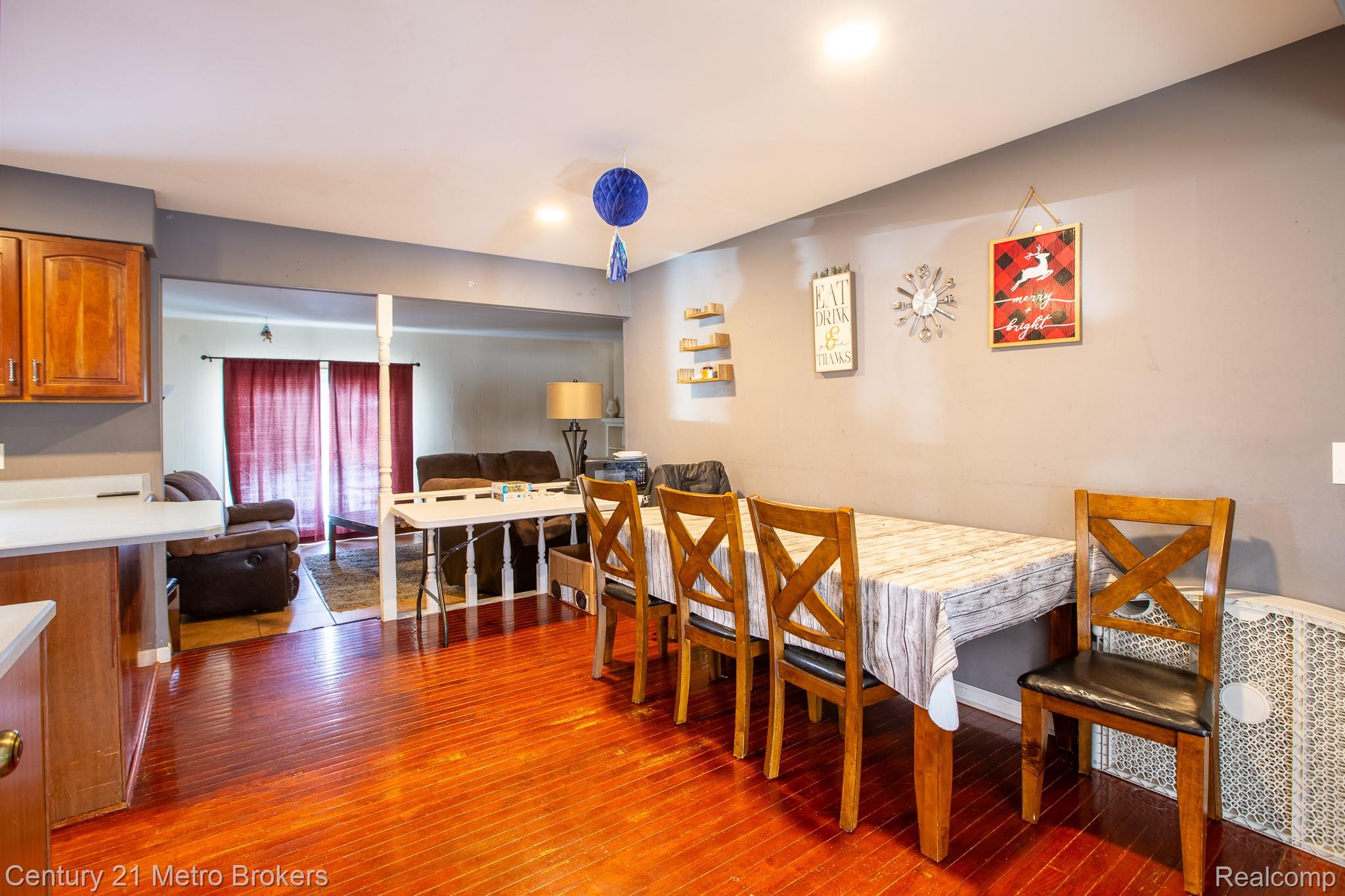 6101 Belsay Road Grand Blanc, MI 48439 - Photo 12 of 28 Dining space featuring dark wood-type flooring and baseboards