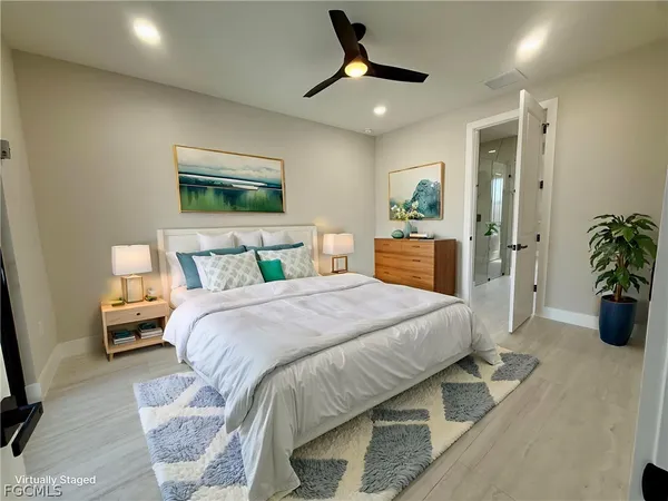 a bedroom with a bed and a painting on the wall