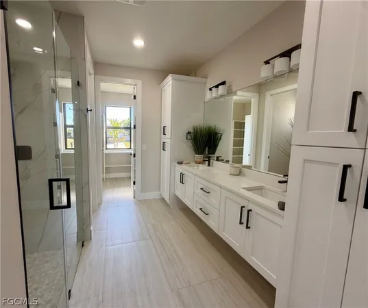 a bathroom with a double vanity sink mirror and shower