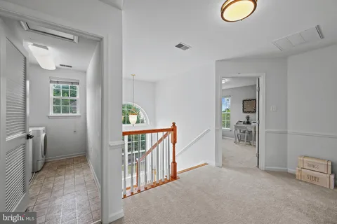 a room with wooden floors and pool table