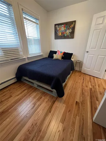 a bed sitting in a bedroom next to a window