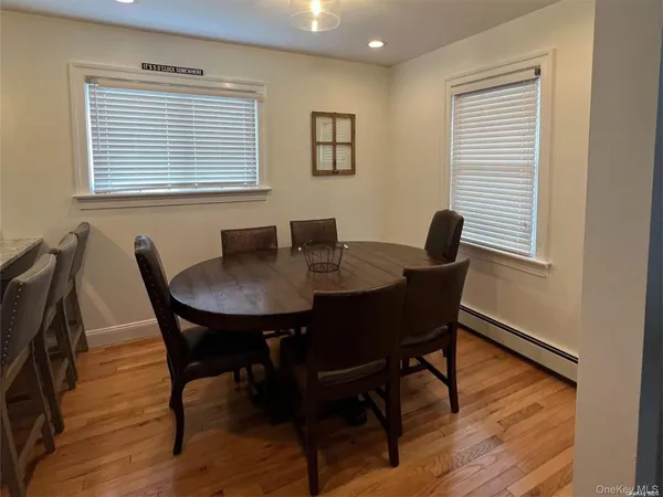 a view of a dining room with a table and chairs