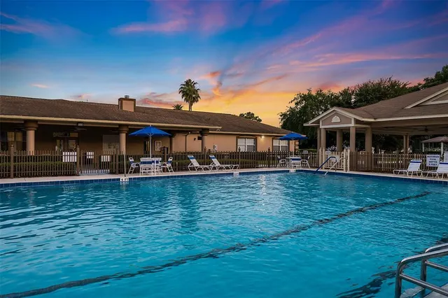a front view of a house with swimming pool yard and outdoor seating