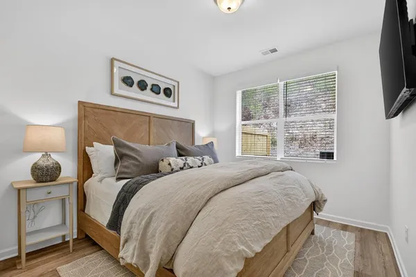 a bedroom with a bed and a window