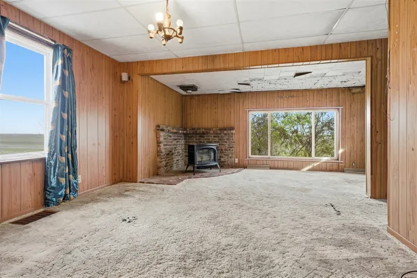 a view of an empty room with a fireplace