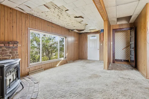 a view of a livingroom with an empty space and a fireplace