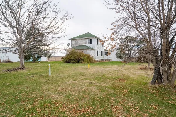 a front view of a house with yard and green space