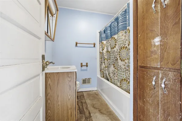 a bathroom with a bathtub and shower