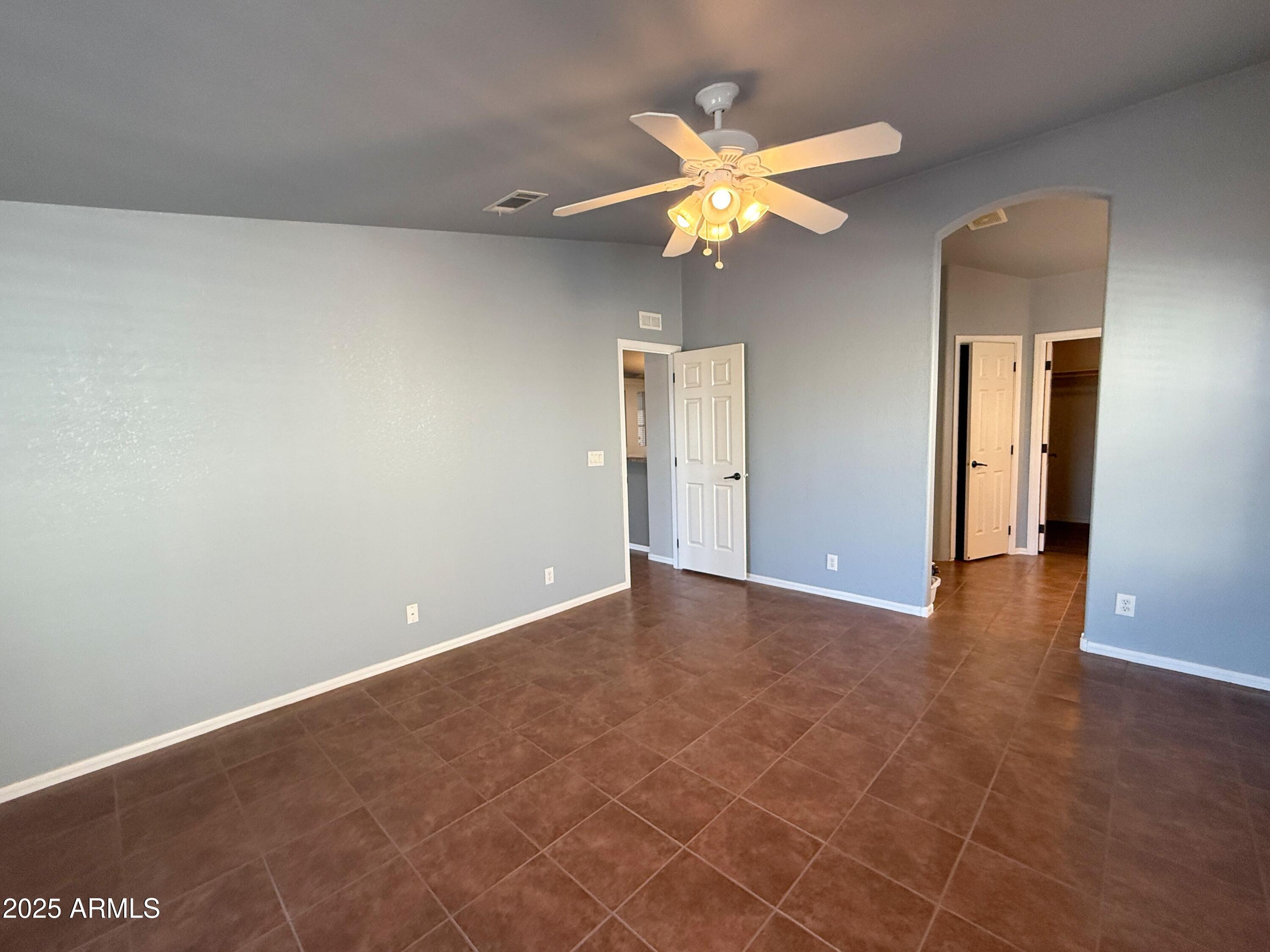 3301 South Goldfield Road, Unit 5078 Apache Junction, AZ 85119 - Photo 14 of 46 a view of an empty room and chandelier fan