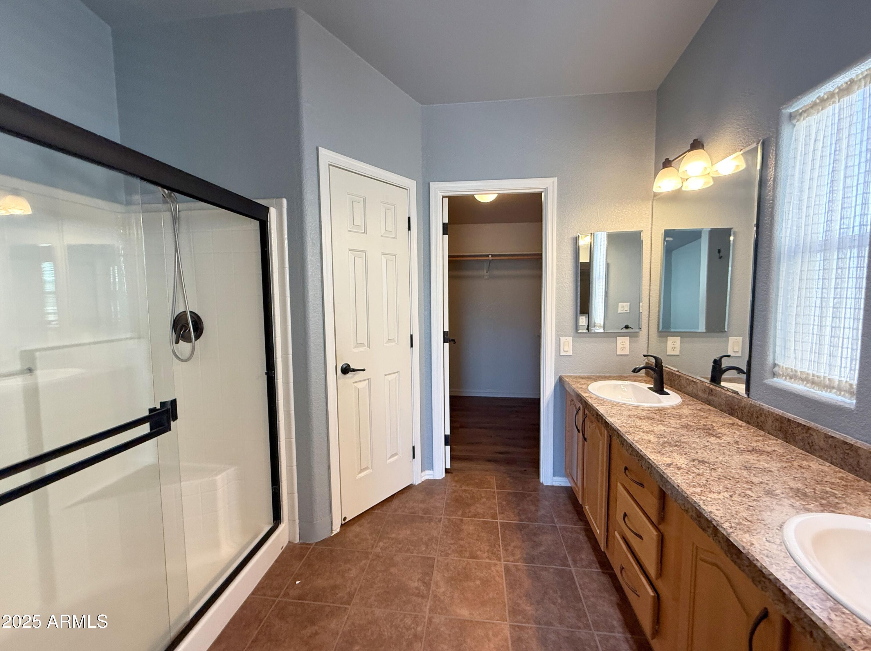 3301 South Goldfield Road, Unit 5078 Apache Junction, AZ 85119 - Photo 15 of 46 a spacious bathroom with a granite countertop sink mirror and shower