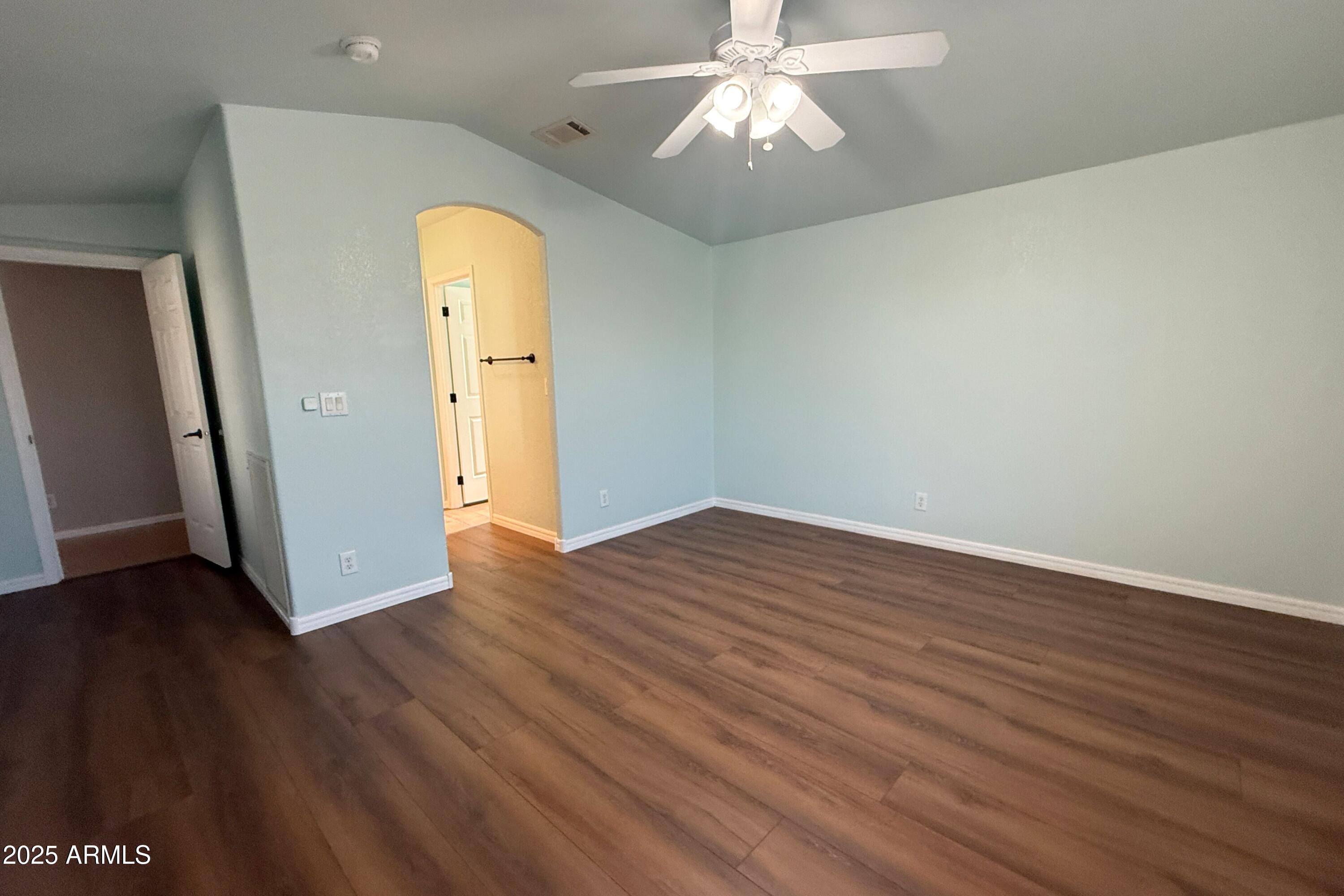 3301 South Goldfield Road, Unit 5078 Apache Junction, AZ 85119 - Photo 19 of 46 wooden floor in an empty room with a window