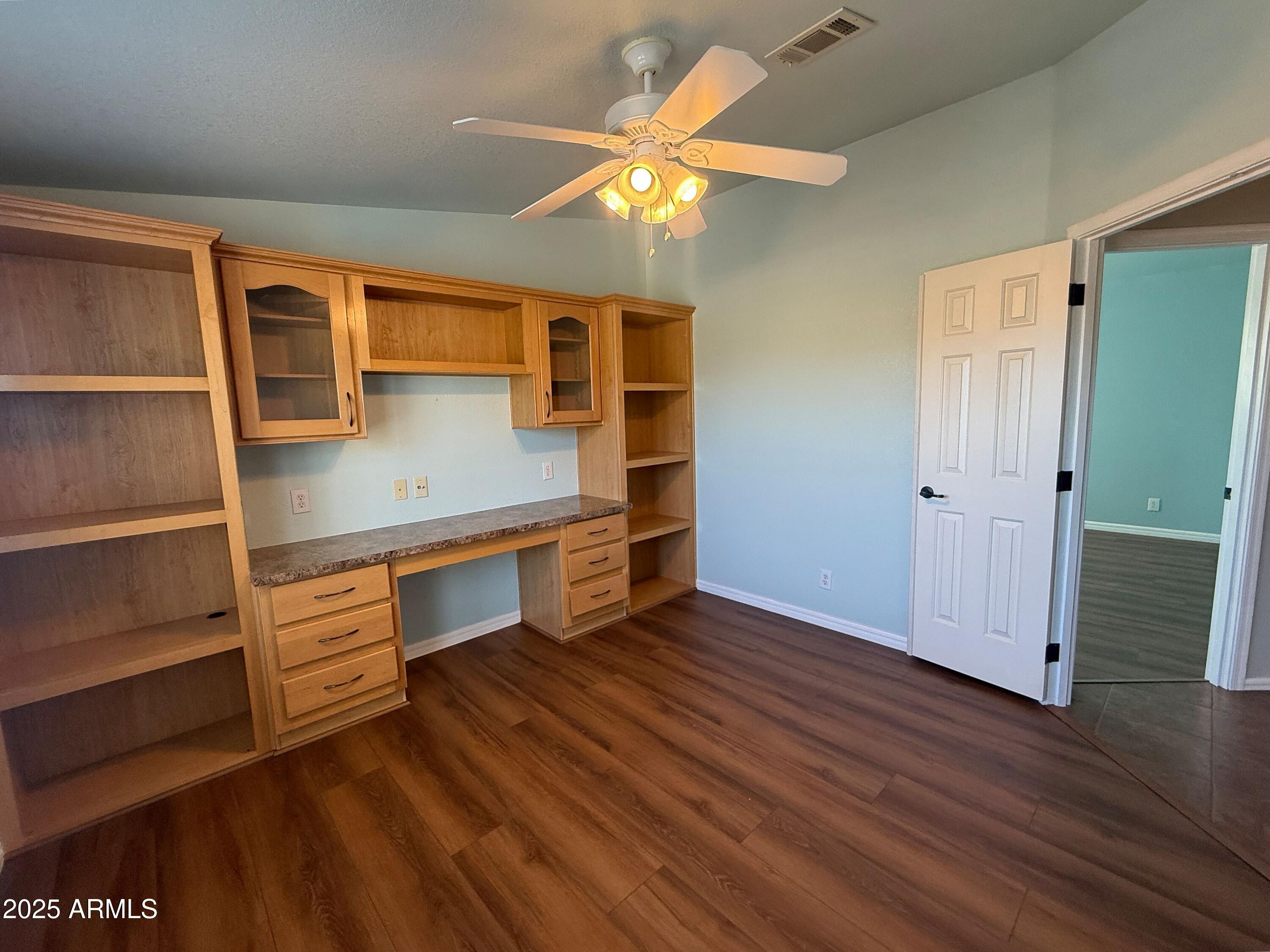 3301 South Goldfield Road, Unit 5078 Apache Junction, AZ 85119 - Photo 29 of 46 wooden floor in an empty room