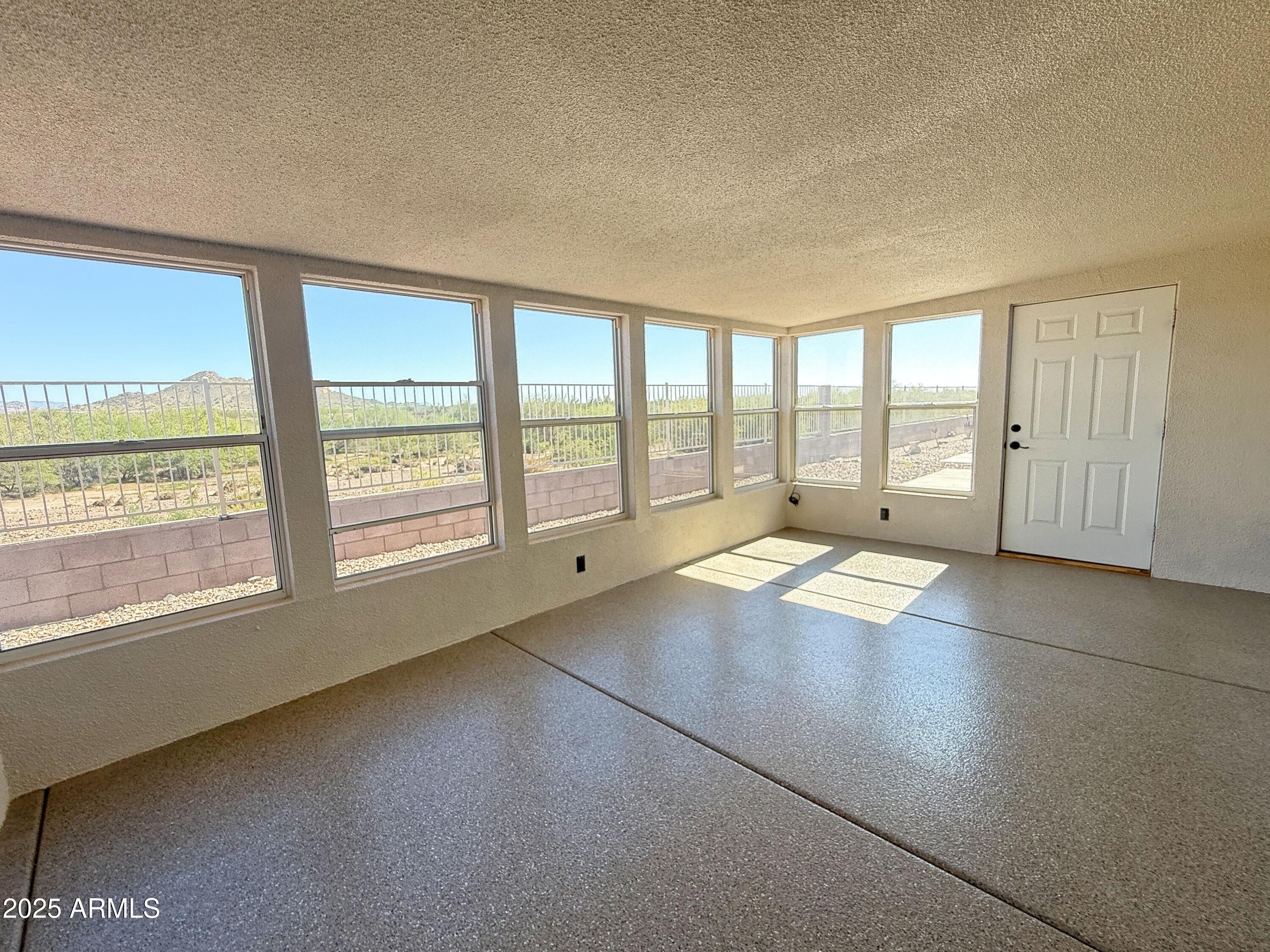 3301 South Goldfield Road, Unit 5078 Apache Junction, AZ 85119 - Photo 33 of 46 wooden floor in an empty room with a window