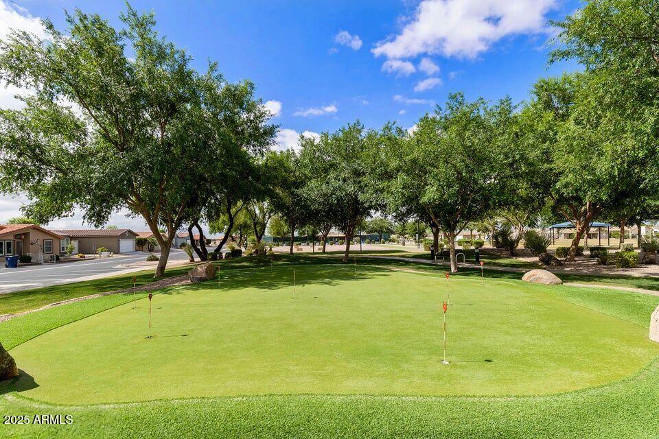 3301 South Goldfield Road, Unit 5078 Apache Junction, AZ 85119 - Photo 40 of 46 a view of a swimming pool with an outdoor space and seating area