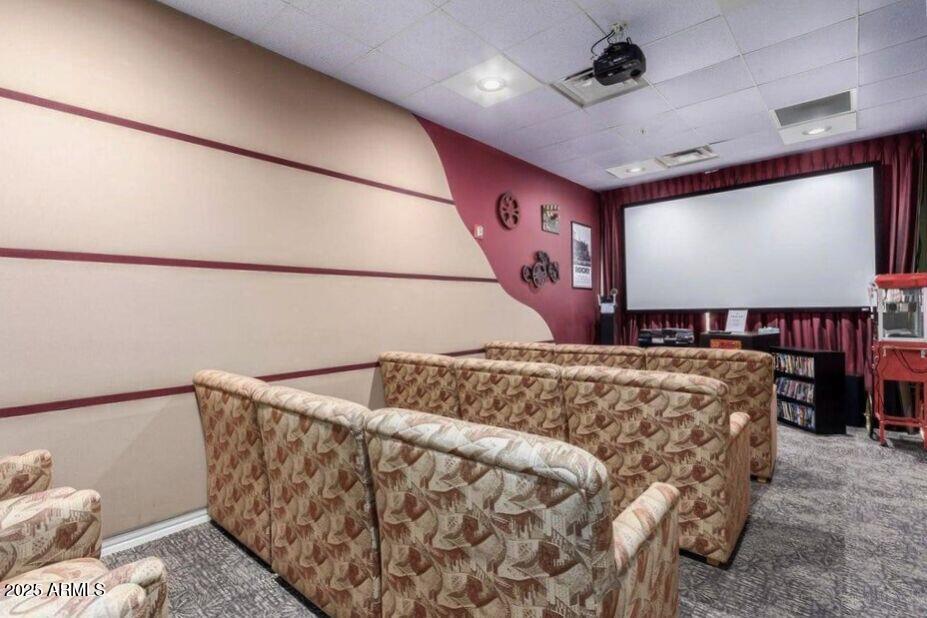 3301 South Goldfield Road, Unit 5078 Apache Junction, AZ 85119 - Photo 44 of 46 a bed sitting in a room next to a projector