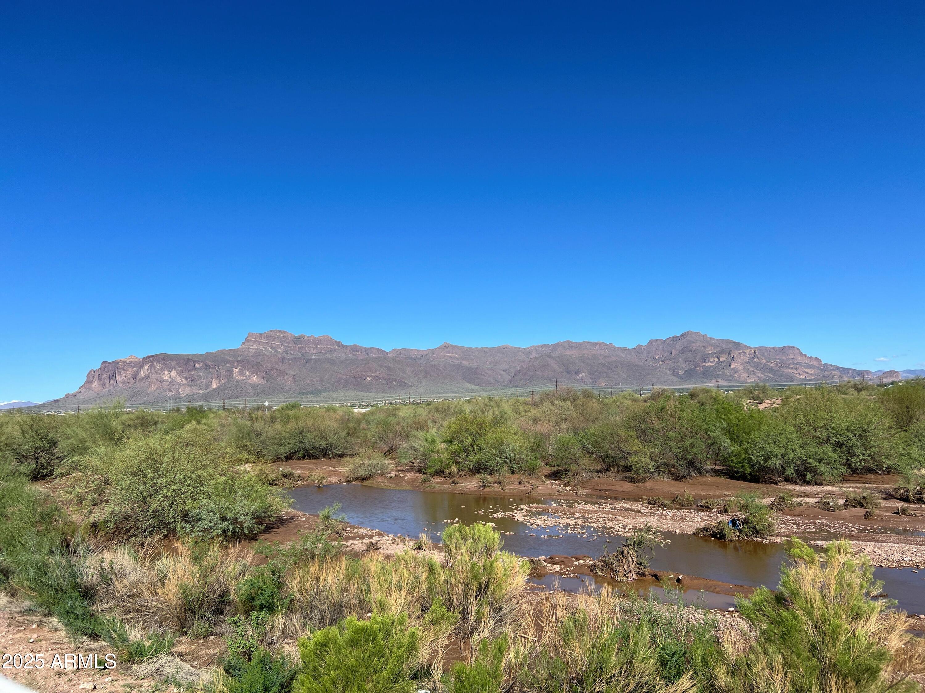 3301 South Goldfield Road, Unit 5078 Apache Junction, AZ 85119 - Photo 45 of 46 a view of a town with mountains in the background