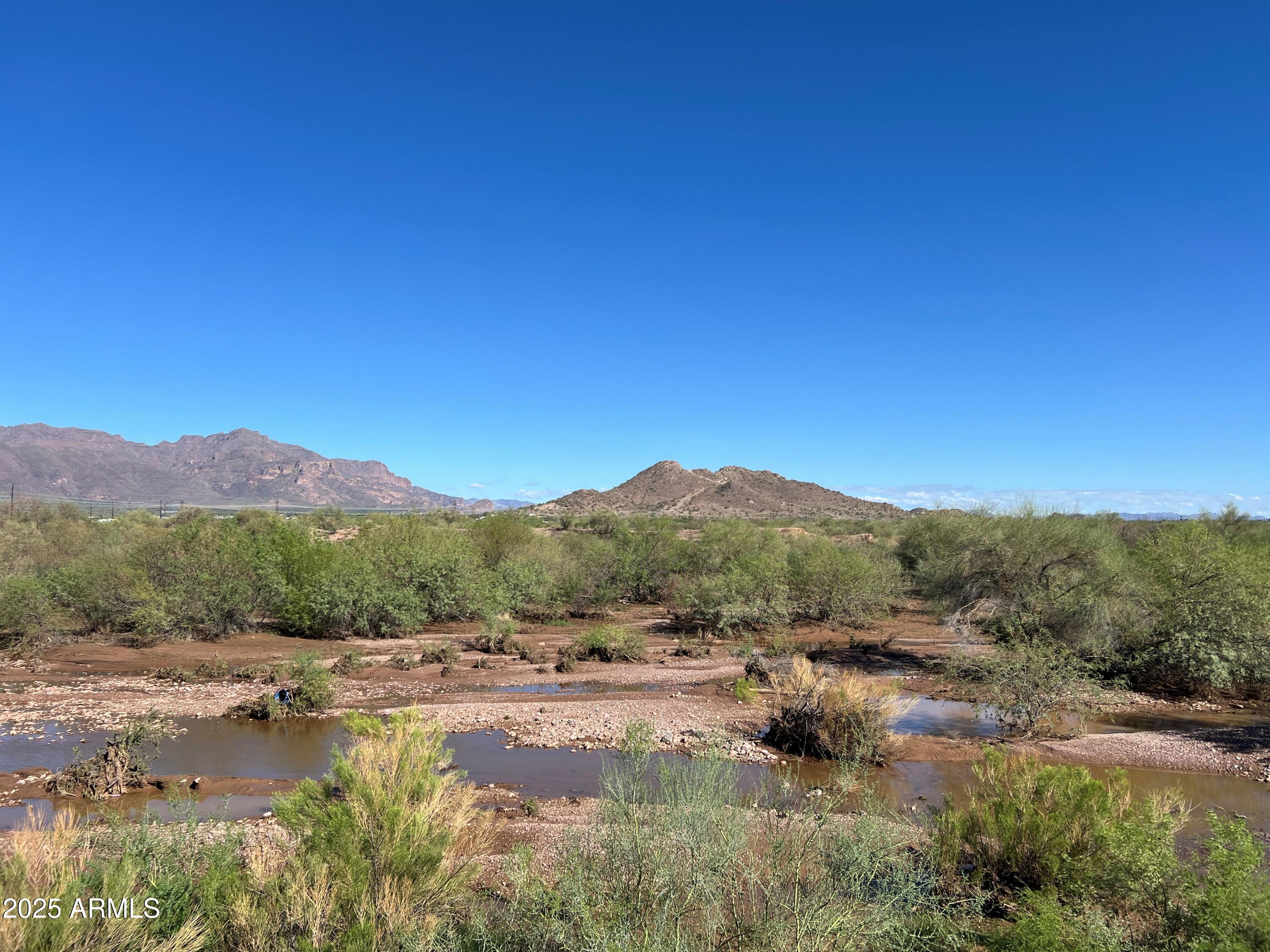 3301 South Goldfield Road, Unit 5078 Apache Junction, AZ 85119 - Photo 46 of 46 a view of a lake with mountains in the background