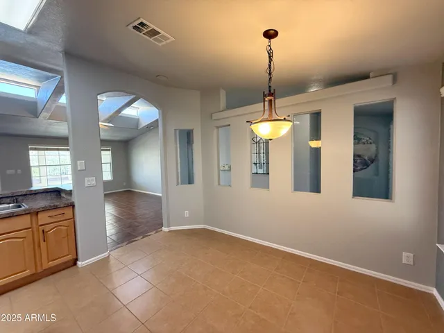 a view of a room with lots of windows and glass door