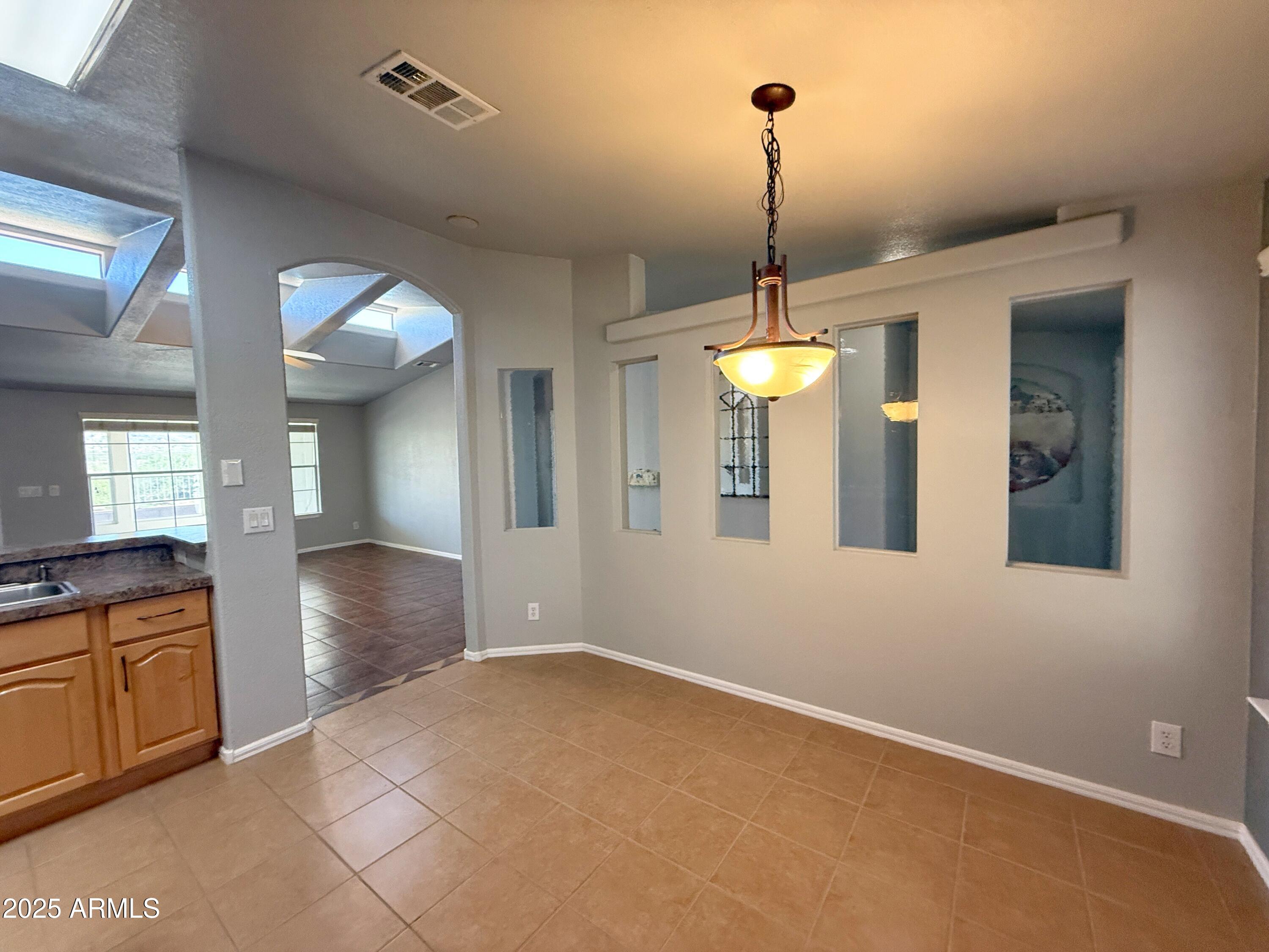 3301 South Goldfield Road, Unit 5078 Apache Junction, AZ 85119 - Photo 10 of 46 a view of a room with lots of windows and glass door