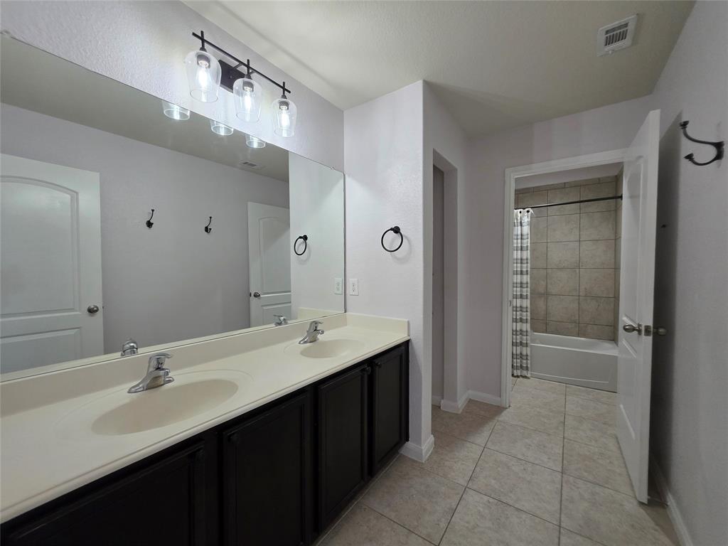 149 Ryan Street Anna, TX 75409 - Photo 23 of 38 a bathroom with a sink double vanity and a mirror